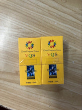 Two yellow 10ml boxes of VQS Oriental Fragrance Science for scars of acne treatment on wooden surface