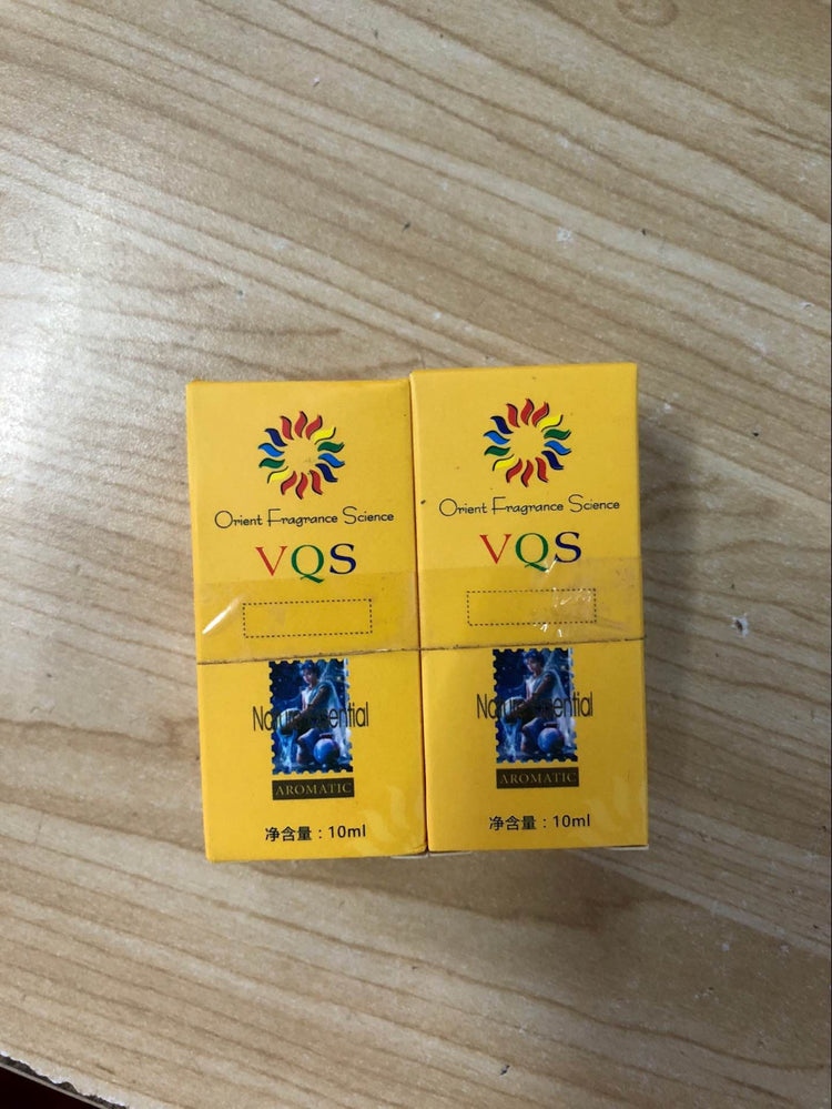 Two yellow 10ml boxes of VQS Oriental Fragrance Science for scars of acne treatment on wooden surface