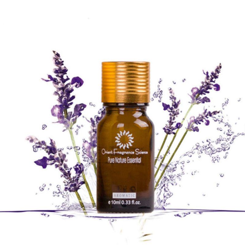 Small amber essential oil bottle with gold cap amid lavender flowers for scars of acne treatment